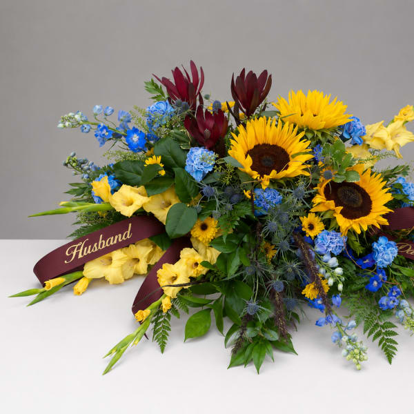 Colorful bouquet with sunflowers, blue flowers, and burgundy blooms