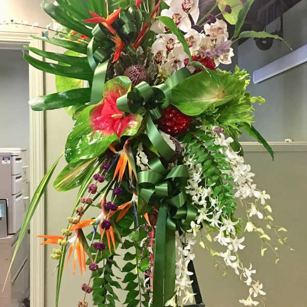 Tall tropical floral standing arrangement with orchids and bird-of-paradise