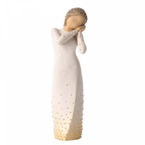 Decorative angel figurine in a long cream dress with gold accents