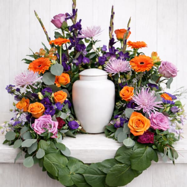 Colorful floral wreath with a white urn in the center