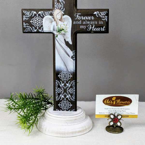 Decorative memorial cross with an angel and flowers on a pedestal base