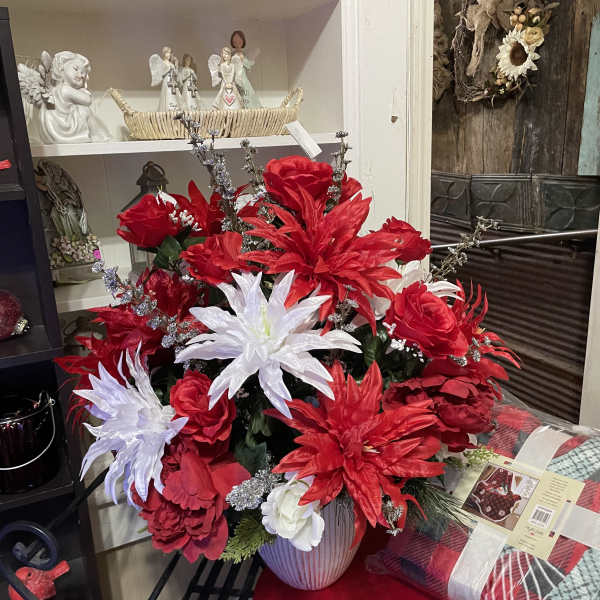 Red and white floral arrangement in a ribbed vase
