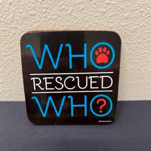 Black sign with blue and white text reading WHO RESCUED WHO