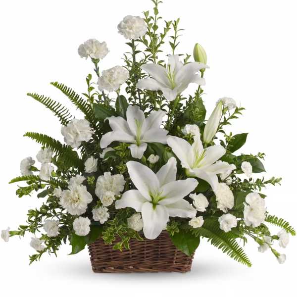 White lilies and carnations in a wicker basket