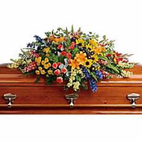 Colorful floral spray on a wooden casket
