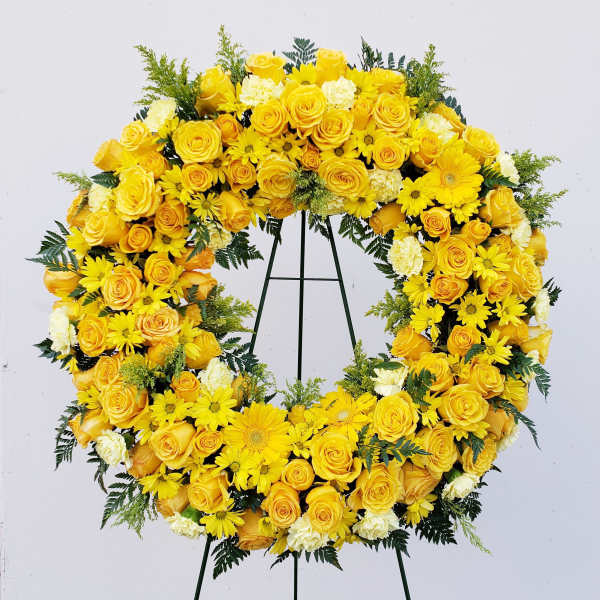 Yellow floral wreath on a black stand