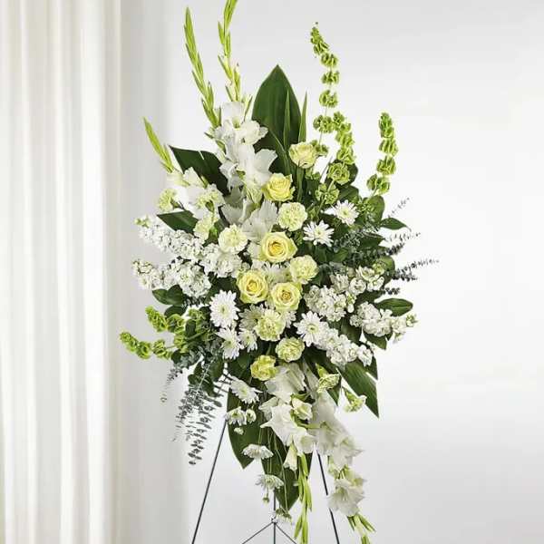 Tall white and pale green floral standing spray on an easel