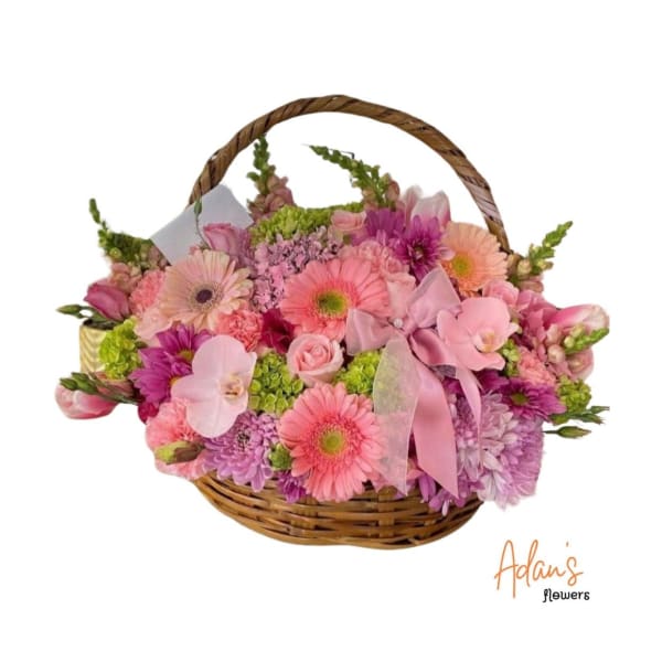 Pink and purple mixed flower basket with a ribbon bow