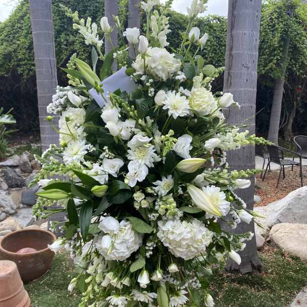 Tall white floral standing spray with lilies and hydrangeas