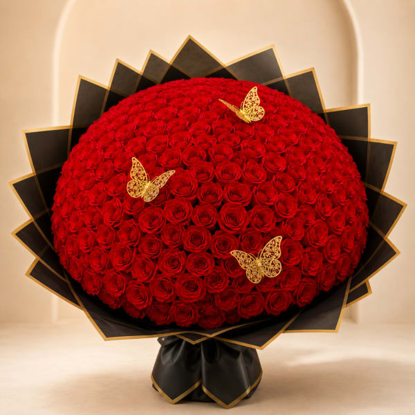 Large dome bouquet of red roses with gold butterfly accents and black wrapping