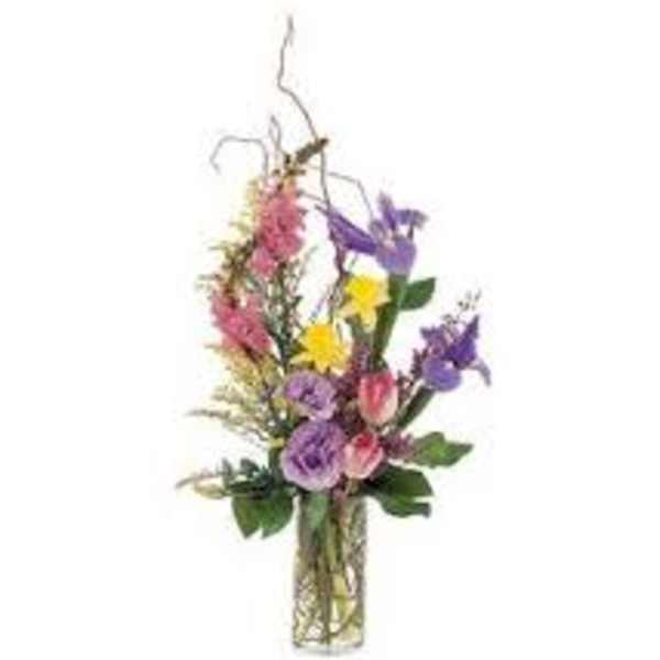 Mixed bouquet of purple, pink, and yellow flowers in a glass vase