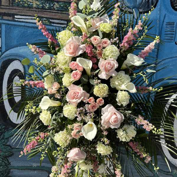 Tall floral spray with pale pink roses, white calla lilies, and pink accents