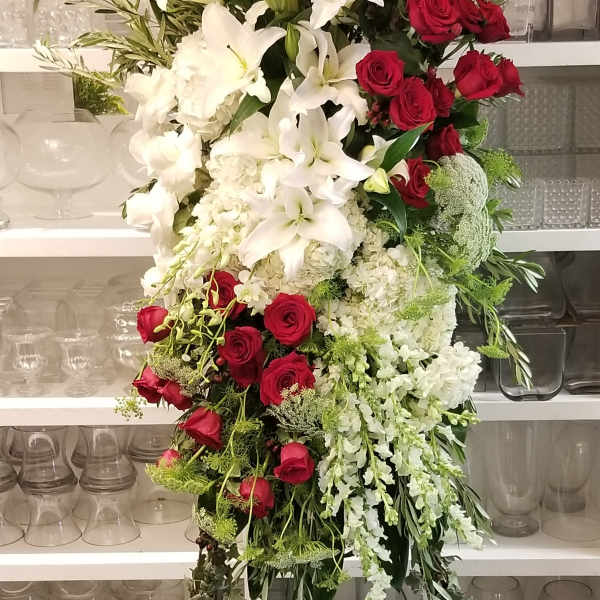 Tall standing floral spray with white lilies and red roses