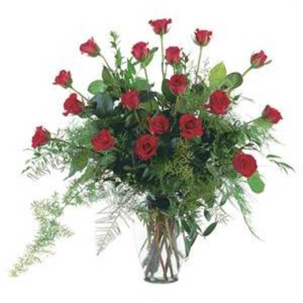 Tall bouquet of red roses in a clear glass vase