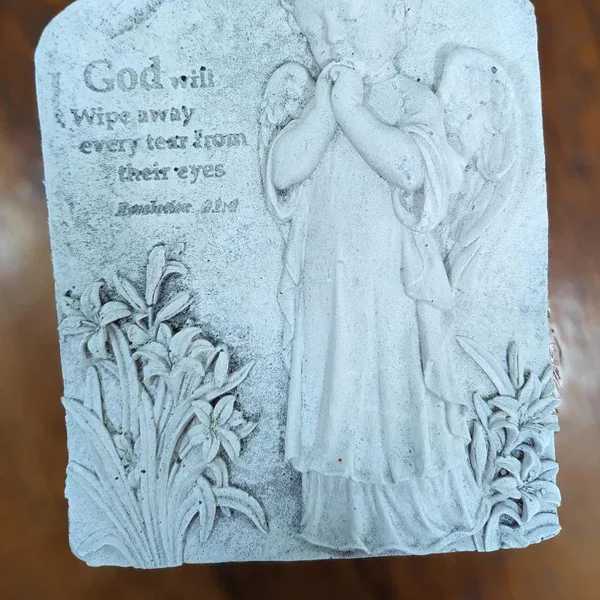Stone plaque with an angel and engraved memorial text
