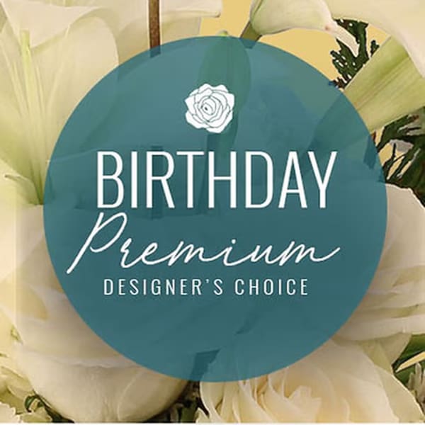 White calla lilies behind a birthday premium designer's choice label