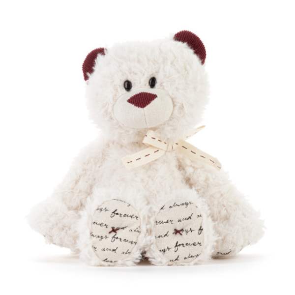 White teddy bear with burgundy ears and nose, tied with a ribbon
