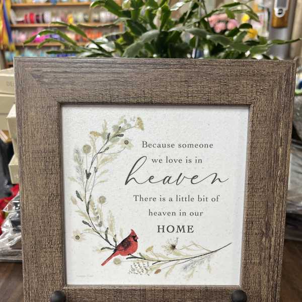 Framed memorial sign with a red cardinal and floral illustration