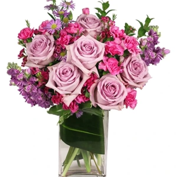 Pink and lavender rose bouquet in a clear glass vase
