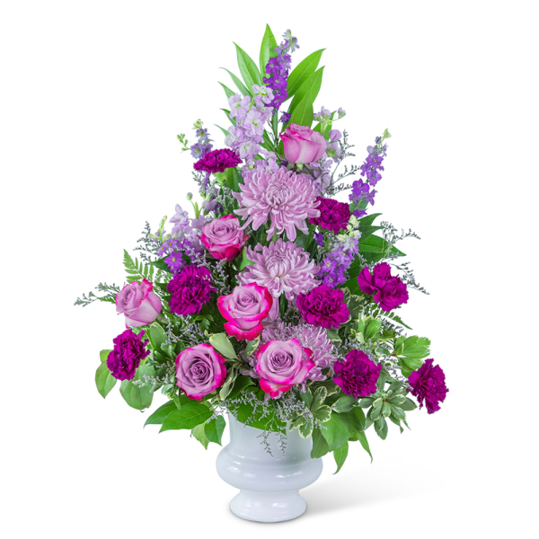 Pink and purple flower arrangement in a white vase