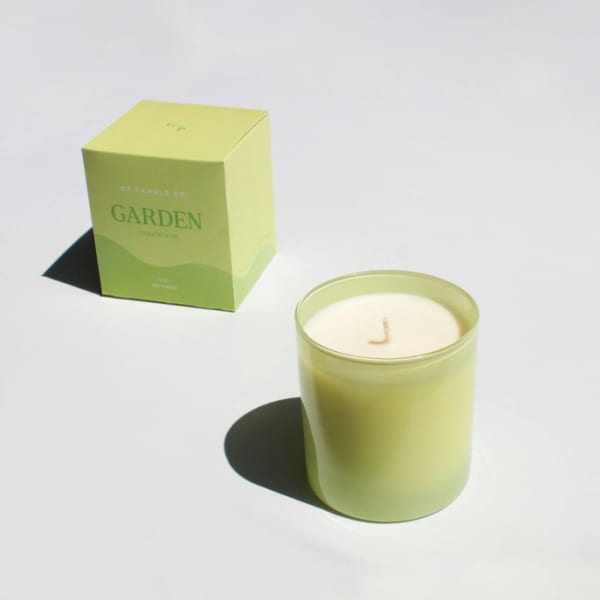 Green candle in a glass jar with matching box