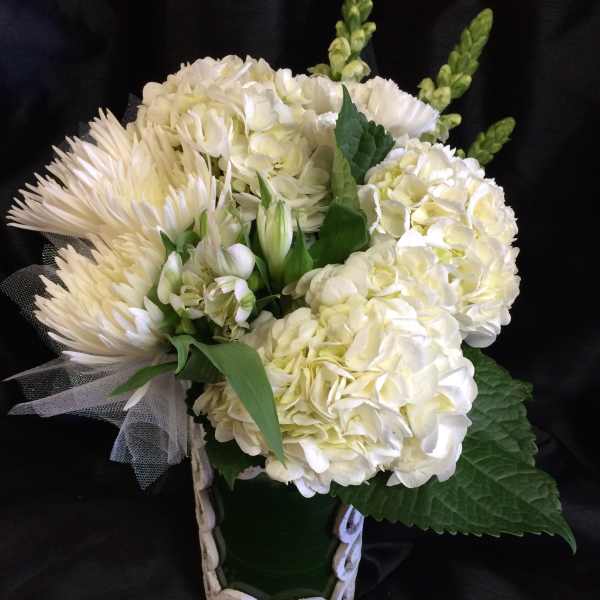 White floral bouquet with hydrangeas and spider mums in a decorative vase