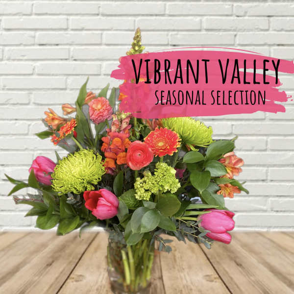 Mixed bouquet of bright flowers in a glass vase