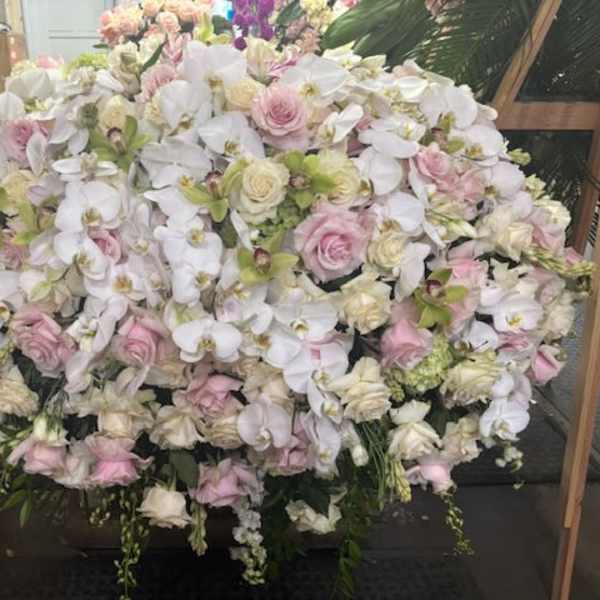 Large arrangement of white orchids and pale pink roses