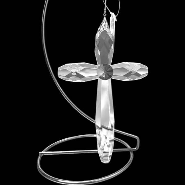 Crystal cross ornament hanging on a silver metal stand