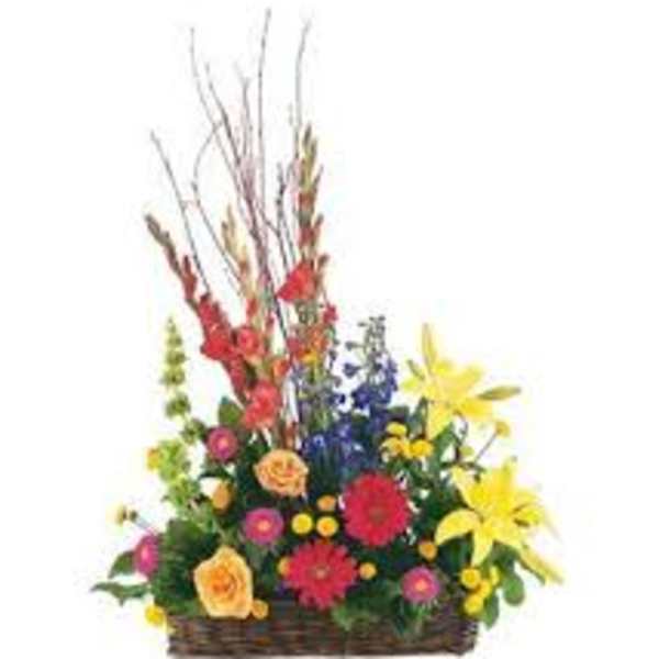Colorful mixed flower arrangement in a wicker basket