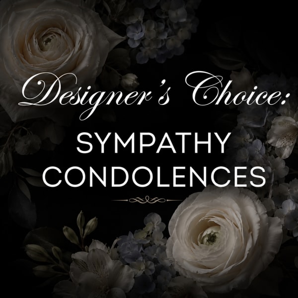 Sympathy condolence floral design with white blooms on a dark background