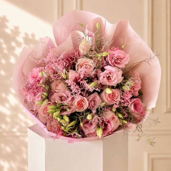 Pink rose bouquet wrapped in pale pink paper