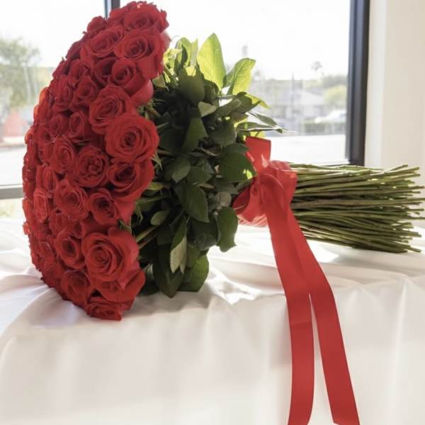 Large bouquet of red roses wrapped with a red ribbon