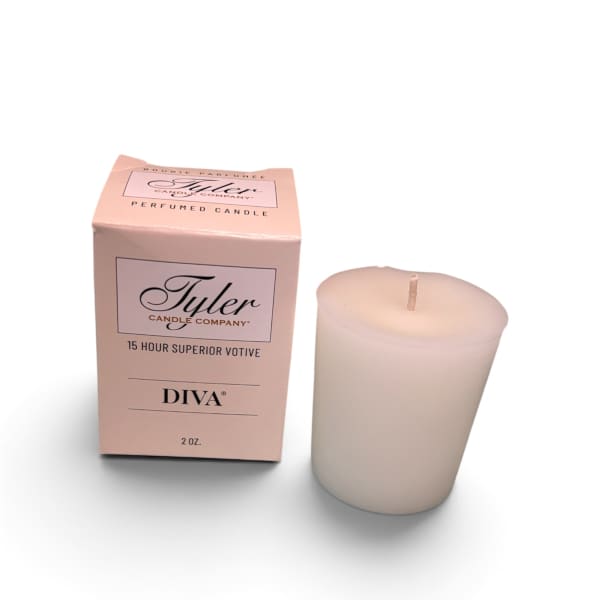 Pink boxed votive candle beside a white candle