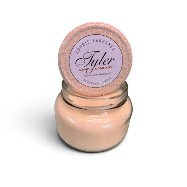 Peach scented candle in a glass jar with a round lid