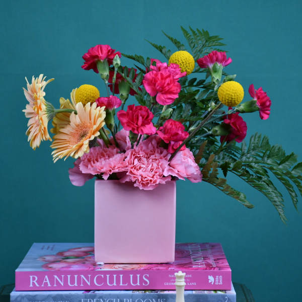 Pink and yellow mixed bouquet in a pink vase