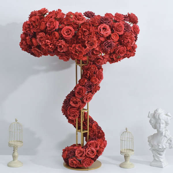 Tall red floral arrangement shaped like a question mark on a gold stand