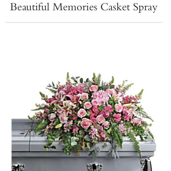 Pink casket spray with roses and lilies