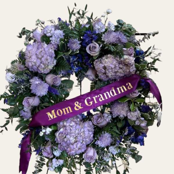 Purple floral standing wreath with a "Mom & Grandma" ribbon