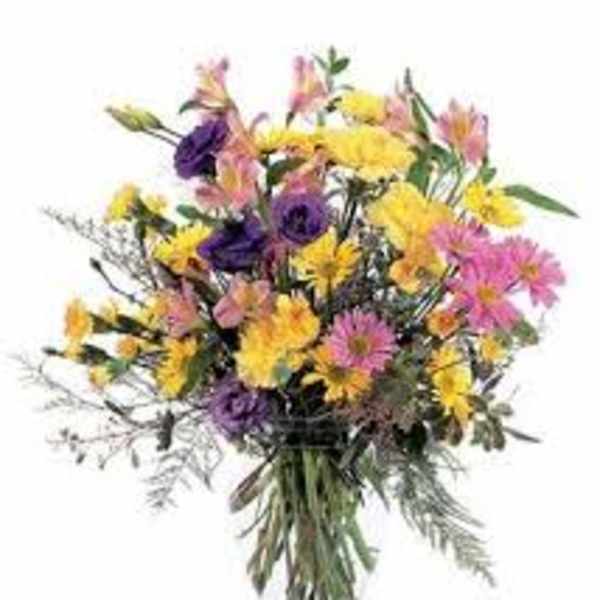 Mixed bouquet of yellow, pink, and purple flowers in a glass vase