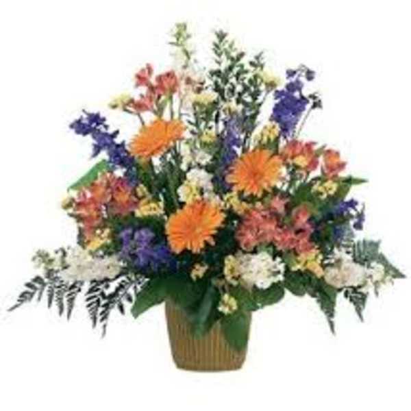 Mixed bouquet of orange, purple, white, and pink flowers in a basket