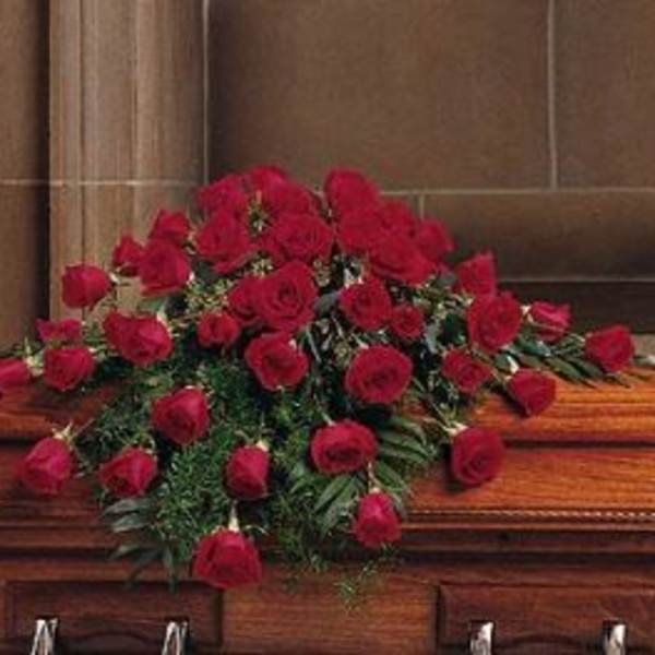 Casket spray of red roses with greenery