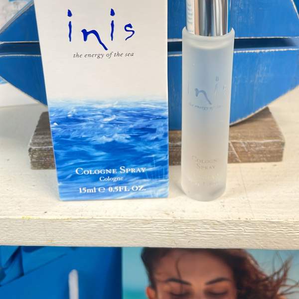 Cologne spray bottle and box with blue ocean-themed packaging