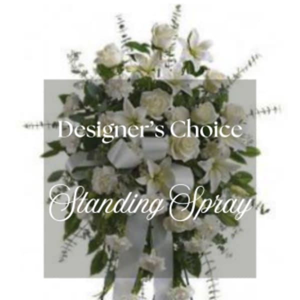 White standing spray with roses and lilies on an easel