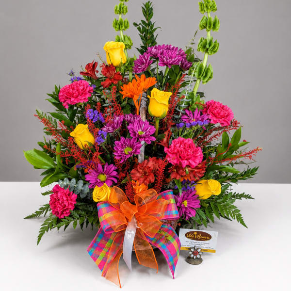 Colorful mixed bouquet with roses, chrysanthemums, carnations, and a plaid ribbon bow