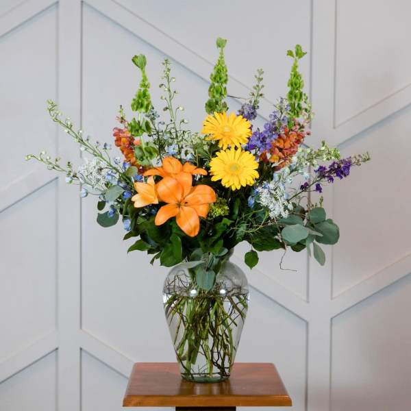 Colorful mixed flower arrangement in a clear glass vase