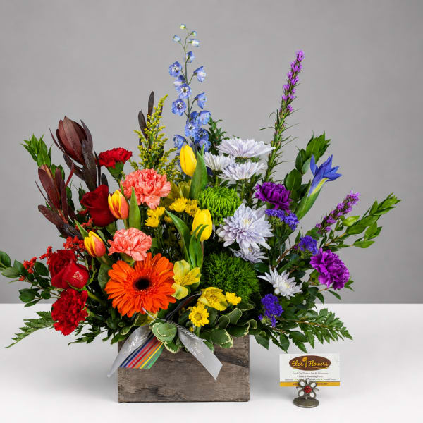 Colorful mixed flower arrangement in a rustic wooden box