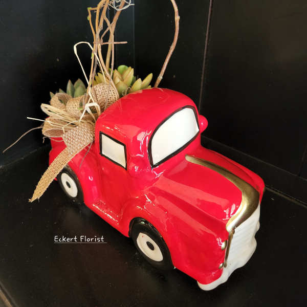 Red truck planter with succulents and a twig topper