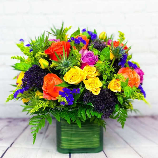 Colorful rose bouquet in a green square vase