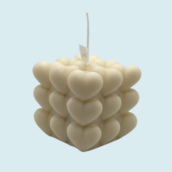 Stacked cream heart-shaped candles with a hanging tag